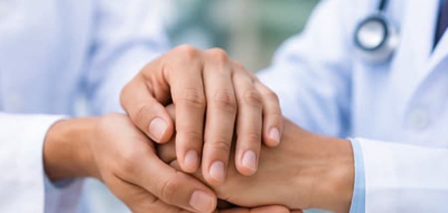 A doctor holding a patient's hand at Vivarch Hospital